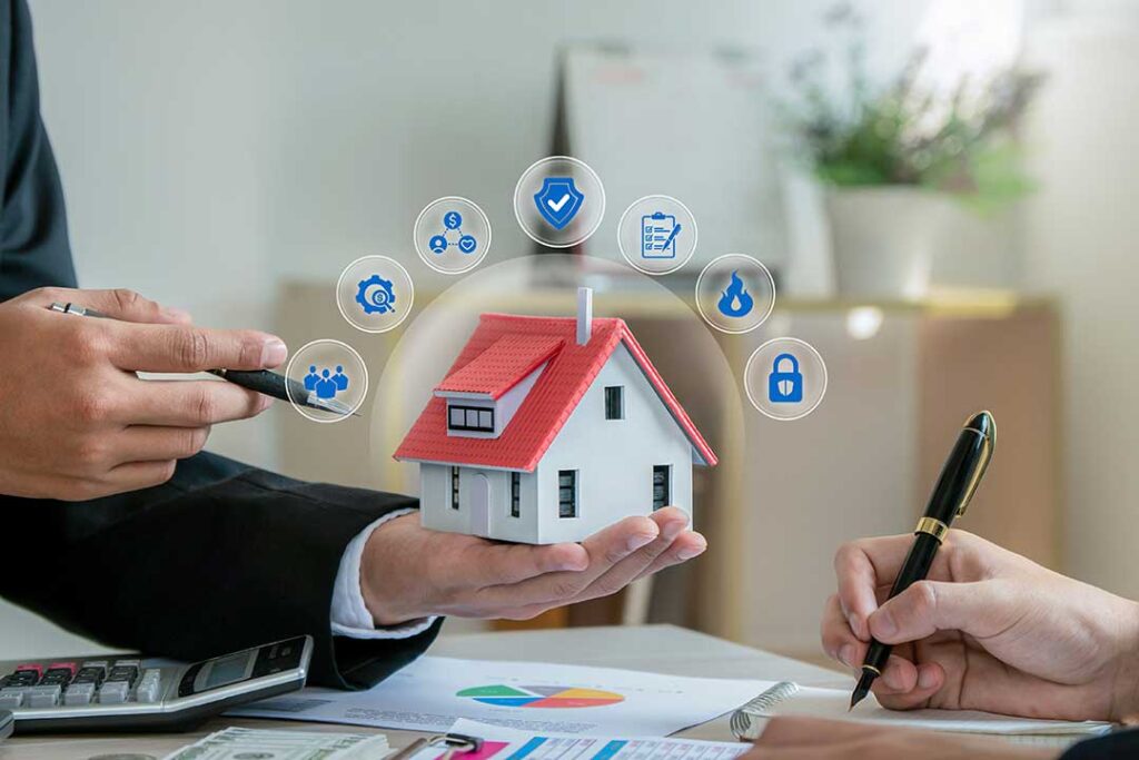 Person reviewing an insurance card beside a smartphone, vehicle keys, and policy papers on a table.